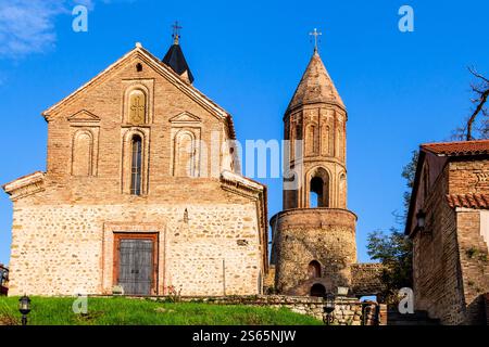 Viaggio in Georgia - vista frontale della Chiesa di San Giorgio illuminata dal sole al tramonto nell'antica città di Sighnaghi nella regione di Kakheti in Georgia in serata d'autunno Foto Stock