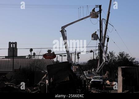 (250116) -- LOS ANGELES, 16 gennaio 2025 (Xinhua) -- i lavoratori delle utility ripristinano le linee elettriche nelle aree colpite dall'incendio di Eaton ad Altadena, California, Stati Uniti, 15 gennaio 2025. Mercoledì, nella California meridionale, i vigili del fuoco continuano a combattere numerosi grandi incendi, mentre alcune zone della regione sono attrezzate per affrontare condizioni di fuoco estremamente critiche causate da una nuova ondata di pericolosi venti di Santa Ana. Feroci incendi in tutta l'area di Los Angeles hanno ucciso almeno 25 persone e distrutto più di 12.300 strutture. Le autorità locali hanno confermato che almeno 26 persone erano ancora scomparse in relazione Foto Stock