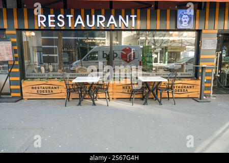 Area esterna con posti a sedere di un intimo ristorante in una città durante il giorno Foto Stock