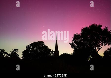 L'aurora boreale colorava il cielo sopra la chiesa di St Giles a Bredon, Worcestershire, Inghilterra. Foto Stock