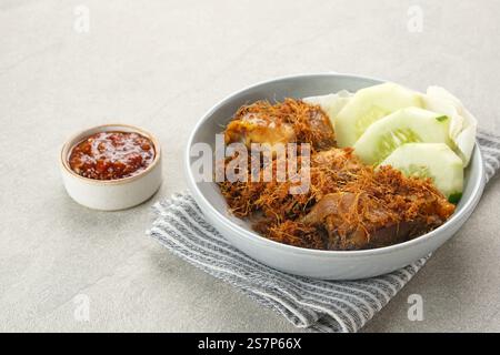 Ayam Goreng Lengkuas, pollo fritto cotto con spezie e cosparso di galangal grattugiato. Cibo tradizionale indonesiano. Foto Stock