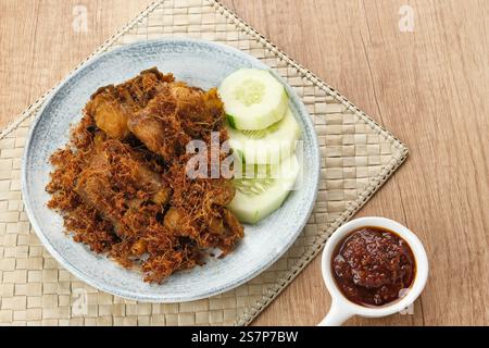 Ayam Goreng Lengkuas, pollo fritto cotto con spezie e cosparso di galangal grattugiato. Cibo tradizionale indonesiano. Foto Stock