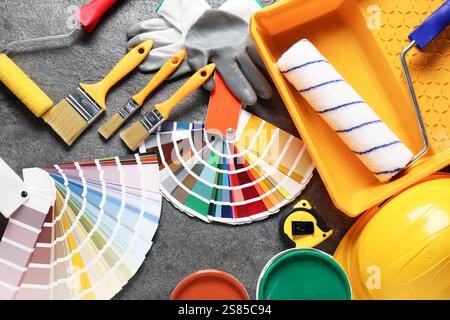 Composizione piatta con diversi strumenti di pittura su tavola grigia. Decorazione e design Foto Stock