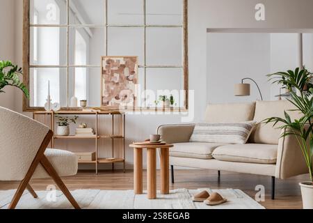Moderna composizione interna del soggiorno con divano beige, tavolino da caffè in legno, piante, quadri e moderni accessori per la casa. Modello. Copia spazio. Foto Stock