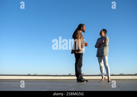 Colleghi d'affari felici che si divertono durante una pausa caffè e si divertono mentre parlano sul balcone Foto Stock