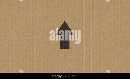 Immagine di una freccia nera su una scatola di cartone Foto Stock