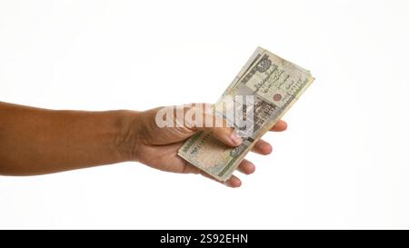 Mano che tiene in mano la valuta della sterlina egiziana su sfondo bianco isolato Foto Stock