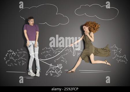 Happy valentines storia d'amore concetto di una coppia romantica su sfondo di disegni di gesso. Uomo intrappolato nel guinzaglio di un simpatico cucciolo Foto Stock