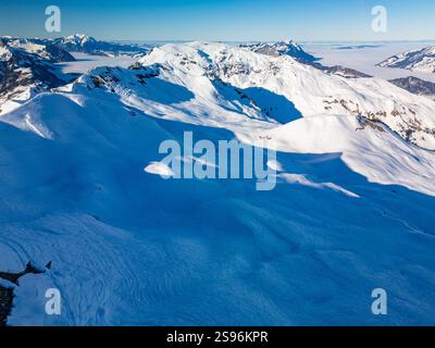 Vista aerea con droni delle montagne innevate e delle piste da sci, area sciistica di Stoos, Svizzera Foto Stock