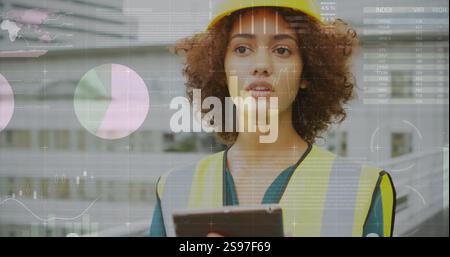 Immagine dell'elaborazione dei dati e diagrammi su lavoratrici birazziali che utilizzano un tablet Foto Stock