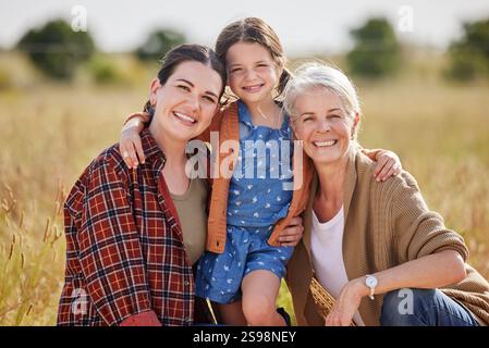 Ritratto, natura e bambino con madre e nonna per l'insegnamento di un'azienda agricola sostenibile o ecologica. Una ragazza all'aperto, che si unisce e felice abbraccia la mamma Foto Stock