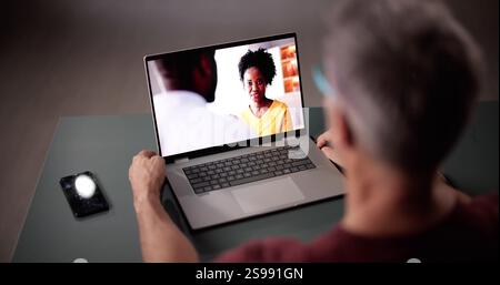 High Angle View Of Young Man Watching Video On Laptop At Home Foto Stock