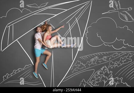 Happy valentines storia d'amore concetto di una coppia romantica su sfondo di disegni di gesso. Coppia su un aquilone che vola sopra un paesaggio, donna che punta Foto Stock