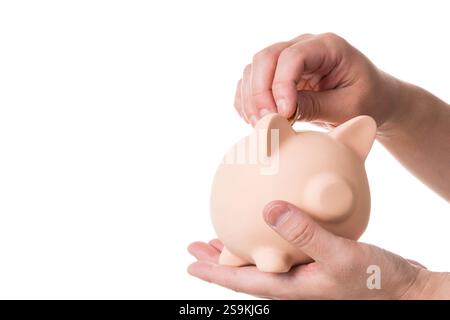 Mettere il denaro in un salvadanaio Foto Stock