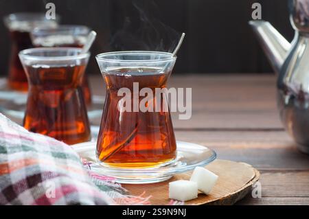 Tazza in vetro di tè turco nero estratto da teiera, tradizionale concetto di bevanda calda Foto Stock