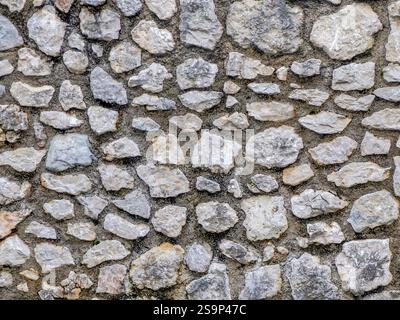 Un dettaglio di un vecchio muro di pietra a trento italia Foto Stock