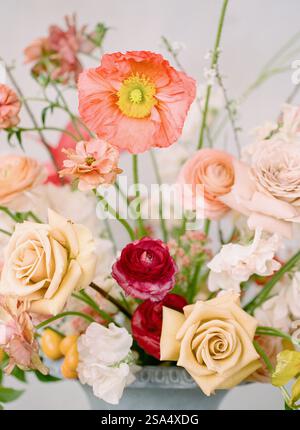 Splendida disposizione floreale caratterizzata da varie rose e delicate fioriture in tenui colori pastello Foto Stock