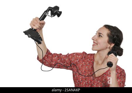 Bella donna cercando di prendere un selfie con un telefono rotaryl Foto Stock