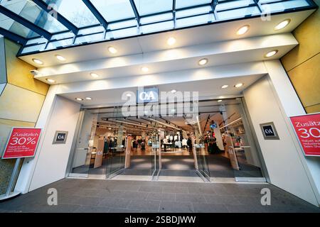 Colonia, Germania gennaio 31 2025: Cartelli pubblicitari rossi di sconto all'ingresso del negozio di abbigliamento C&A in schildergasse nel centro di colonia Foto Stock