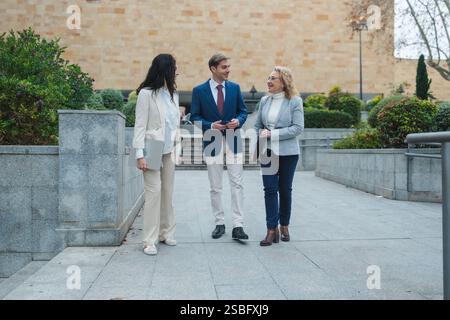 Uomini d'affari che camminano e parlano sulla strada della città Foto Stock