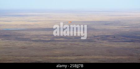 La Sojuz MS-19 scende sulla Terra con paracadute in un'area remota del Kazakistan con i membri dell'equipaggio della Expedition 66 Mark Vande Hei della NASA, e i cosmonauti Pyotr Dubrov e Anton Shkaplerov di Roscosmos a bordo. Vande Hei e Dubrov stanno tornando sulla Terra dopo 355 giorni nello spazio a bordo della stazione spaziale Internazionale. Per Vande Hei, la missione rappresenta il volo spaziale più lungo della storia di un astronauta statunitense. Vicino a Zhezkazgan, Kazakistan, 30 marzo 2022. Foto Stock