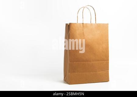 Un sacchetto di carta marrone ecocompatibile con robuste manici che mostra un'alternativa sostenibile per le esigenze di shopping e imballaggio. Foto Stock