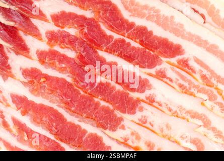Texture di fondo scottante striata di pancetta cruda britannica affumicata e stagionata a secco Foto Stock