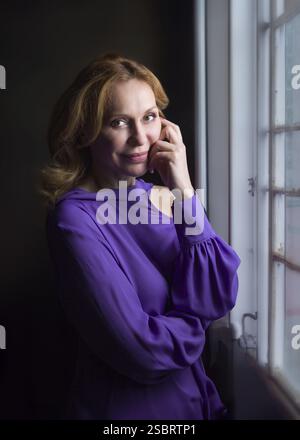 Felice elegante donna anziana matura su sfondo grigio. Donna degli anni '50 sicura e allegra Foto Stock