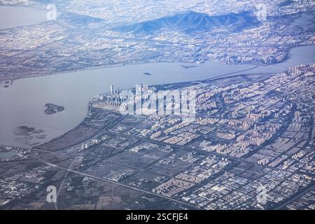 Vista della città di Shenzhen dalla finestra di un aereo. Distretti della capitale provinciale con grattacieli. Foto Stock