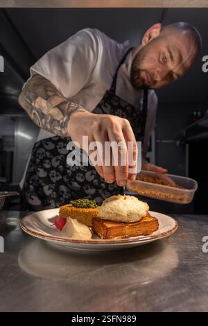 Lo chef prepara piatti gourmet con crostini nella cucina del ristorante Foto Stock