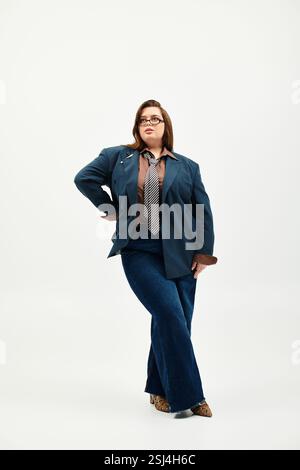 Uno spazio luminoso e arioso mette in risalto una giovane donna di taglia superiore che posa con sicurezza in un outfit alla moda. Foto Stock