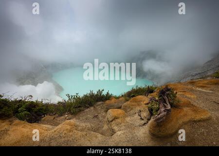 Nuvole che scendono nel vulcano Ijen, lago acido cratere sull'isola di Giava Foto Stock