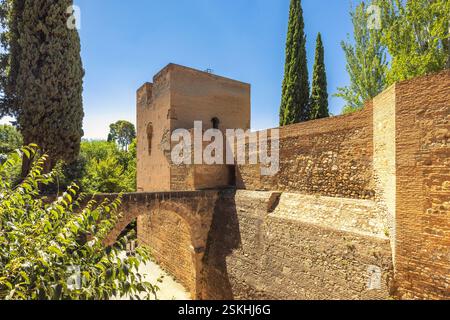 Acquedotto dell'Acequia Real nel complesso dell'Alhambra, città di Granada, Andalusia, Spagna. Antiche mura di pietra e torre bagnate dalla luce del sole Foto Stock