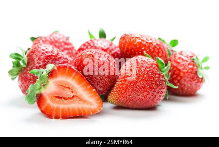 Fragole fresche disposte artisticamente con una tagliata a metà che mostra un interno succoso su sfondo bianco Foto Stock