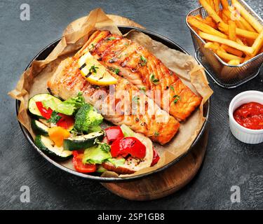 Bistecca di salmone con verdure. Grigliata al momento. Cena salutare. Dieta mediterranea. Foto Stock