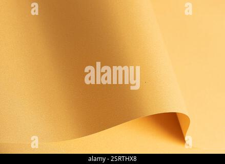 Sfondo in carta giallo dorato con una trama uniforme e sfumatura morbida. Design astratto elegante, sofisticato e armonioso. Foto Stock