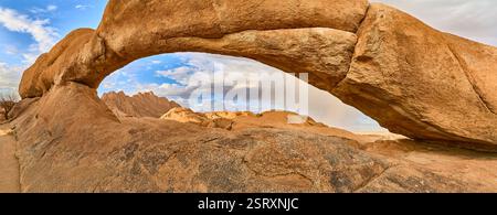The Rock Arch con il piccolo Spitzkoppe sullo sfondo, nuvole e una doccia a pioggia con un arcobaleno, Spitzkoppe, Namibia, Africa Foto Stock