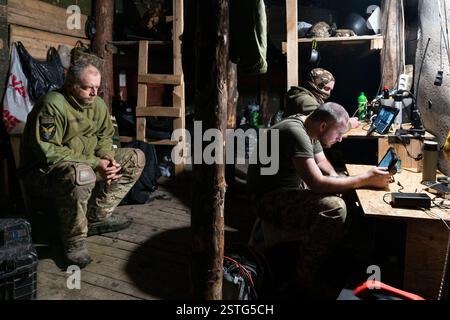 Ucraina. 22 dicembre 2024. All'interno di un bunker sotterraneo, gli operatori di droni ucraini volano un drone per colpire le posizioni russe in prima linea. La guerra tra Ucraina e Russia ha dimostrato quanto i droni economici e sacrificabili, come il kamikaze o i modelli che lanciano bombe, stiano rimodellando la guerra. Questi droni consentono attacchi precisi e a basso costo e si sono dimostrati estremamente efficaci nell'interrompere le operazioni nemiche. Di conseguenza, stanno cambiando le strategie militari, segnalando un futuro in cui i droni svolgono un ruolo centrale nel combattimento, riducendo la dipendenza dalle armi tradizionali e costose. (Immagine di credito: © Miguel Cande Foto Stock