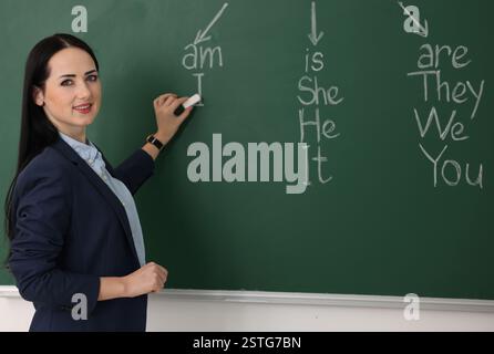Insegnante di inglese durante la lezione vicino alla lavagna in classe Foto Stock