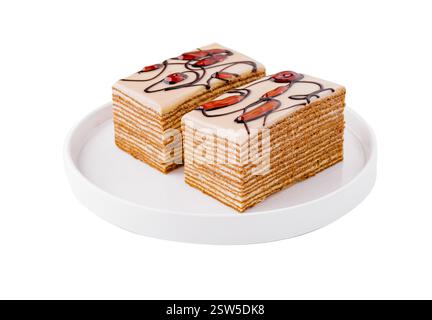 Deliziose fette di torta al miele su un piatto bianco Foto Stock
