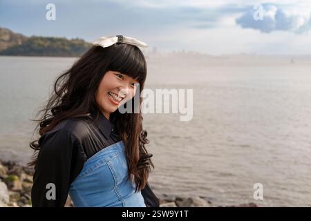 Giovane donna che indossa Bow San Francisco Bay Cloudy Day Foto Stock