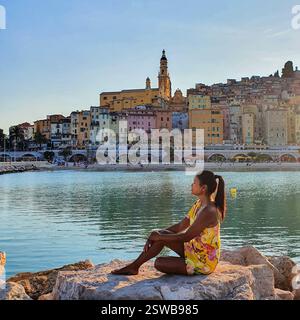Un momento tranquillo in riva al mare per catturare la bellezza di edifici colorati al tramonto Foto Stock
