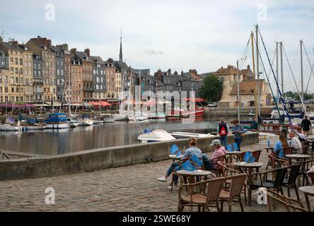 30.08.2024, Francia, Normandia, Honfleur - barche sul Quai Sainte-Catherine e persone in via Cafè nel vecchio porto, Vieux Bassin, nel pict Foto Stock