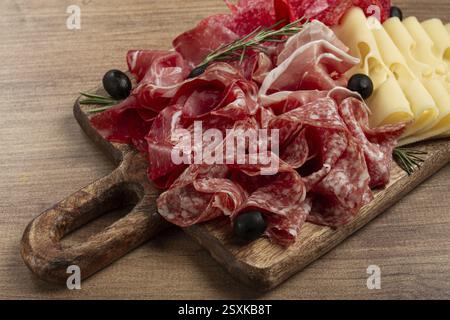 Carne assortita, antipasto, prosciutto, salame e prosciutto, con formaggio maasdam e olive, su una tavola di legno, colazione, vista dall'alto, vista ravvicinata, nessuno Foto Stock