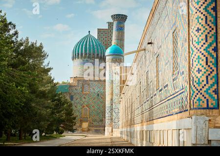 Splendida cupola blu e minareto con torri nel vecchio complesso pubblico di Registan nel cuore dell'antica città di Samarcanda, Uzbekistan. Turista e. Foto Stock