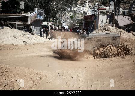Tulkarm, Palestina. 26 febbraio 2025. Un veicolo militare israeliano pattuglia le strade del campo profughi distrutto di Nur Shams. Le forze israeliane hanno permesso ai residenti di recuperare i loro effetti personali dopo aver emesso avvisi di demolizione per diverse case, nel mezzo di un assalto di settimane in Cisgiordania che ha allontanato circa 30.000 palestinesi dalle loro case all'interno del campo profughi di Nur Shams. Credito: SOPA Images Limited/Alamy Live News Foto Stock