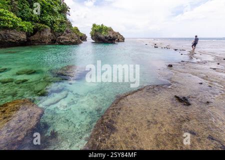 Splendida vista sulla spiaggia presso la piscina e gli appartamenti di roccia Magpupungko a Siargao, Filippine, una popolare destinazione turistica conosciuta per le piscine di marea e la bellezza paesaggistica Foto Stock