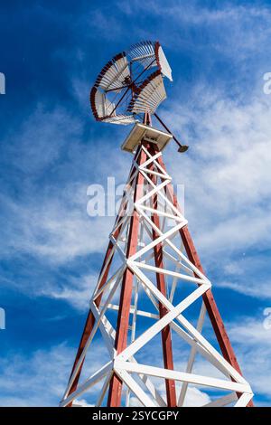 Mulino a vento alto con base bianca e cima rossa. Il mulino a vento è su un palo Foto Stock