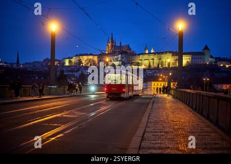 Praga, capitale della Repubblica Ceca, Tatra T3R.P 8399, percorso 22 che attraversa il ponte Manes e il castello di Praga di notte Foto Stock