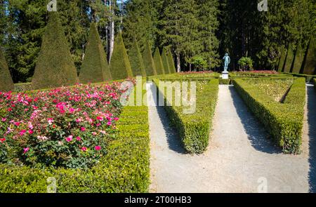 La statua di Ercole nel giardino formale di roseraie nel terreno del castello che contiene il Museo della Rivoluzione francese, Vizille, Francia. Foto Stock